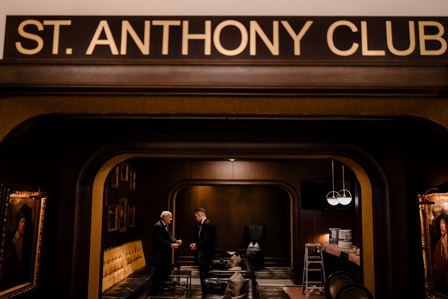 Elegant interior with two men conversing.