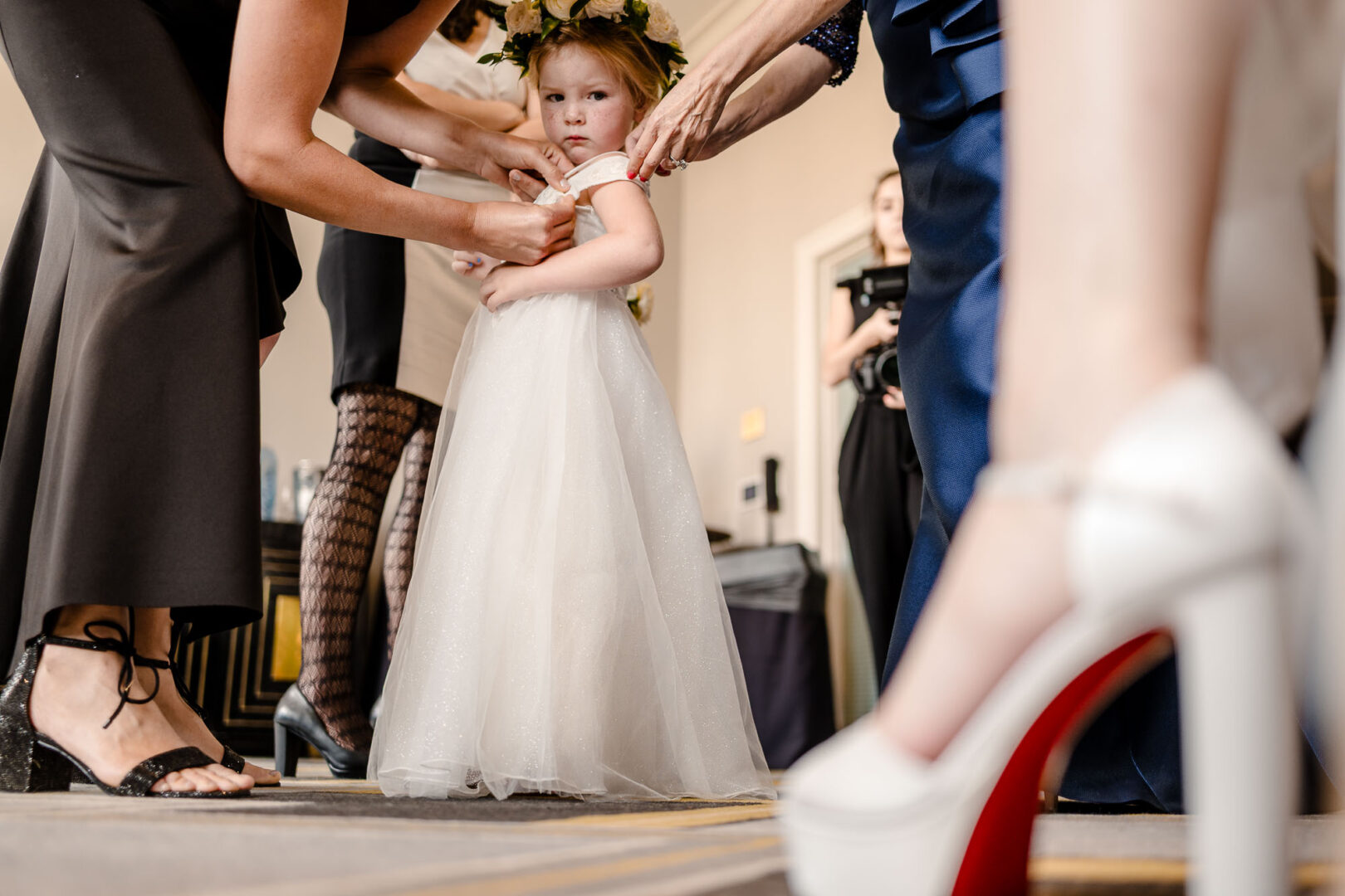Child in white dress getting ready