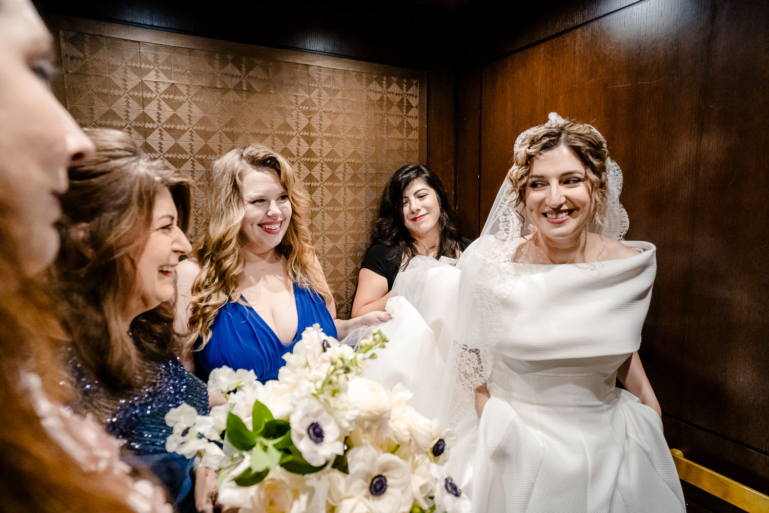 Bridal party preparing in elevator.