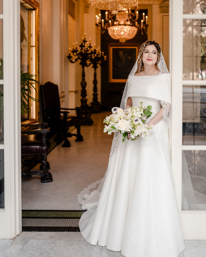 Bride in elegant wedding dress, bouquet.