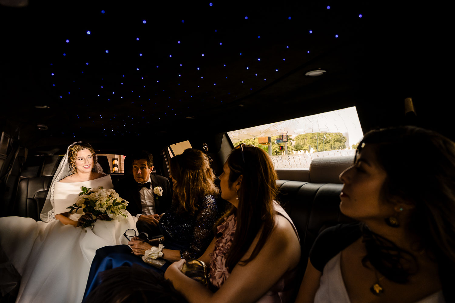 Bride and bridesmaids in limousine.
