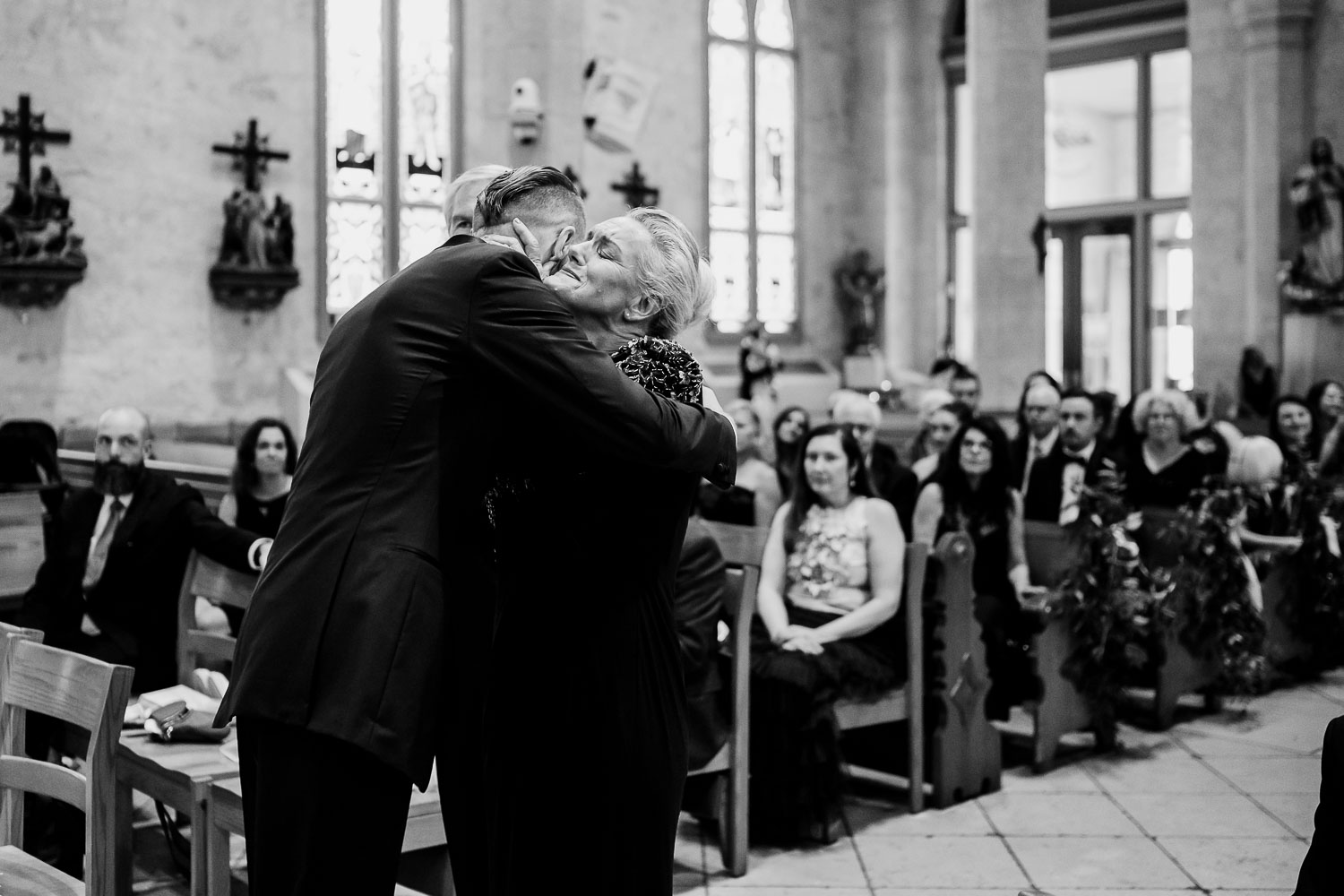 Couple embracing during wedding ceremony.