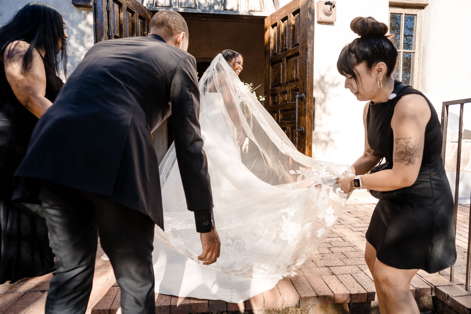 Lost Mission Wedding Ceremony + Reception | Peyge + Luis 18 Checking and fluffing the brides gown before entering the chapel