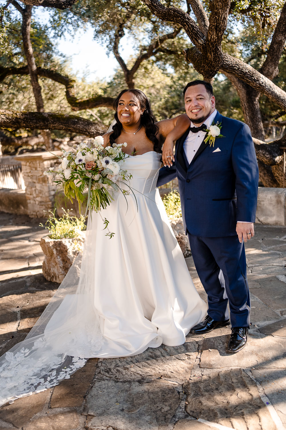 Lost Mission Wedding Ceremony + Reception | Peyge + Luis 25 Couple relaxing as they watch guests leave the wedding chapel at Lost Mission, San Antonio shot 50mm summicron and Leica Sl3-s