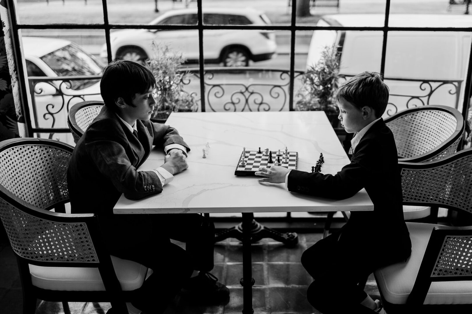 Two boys playing chess indoors.