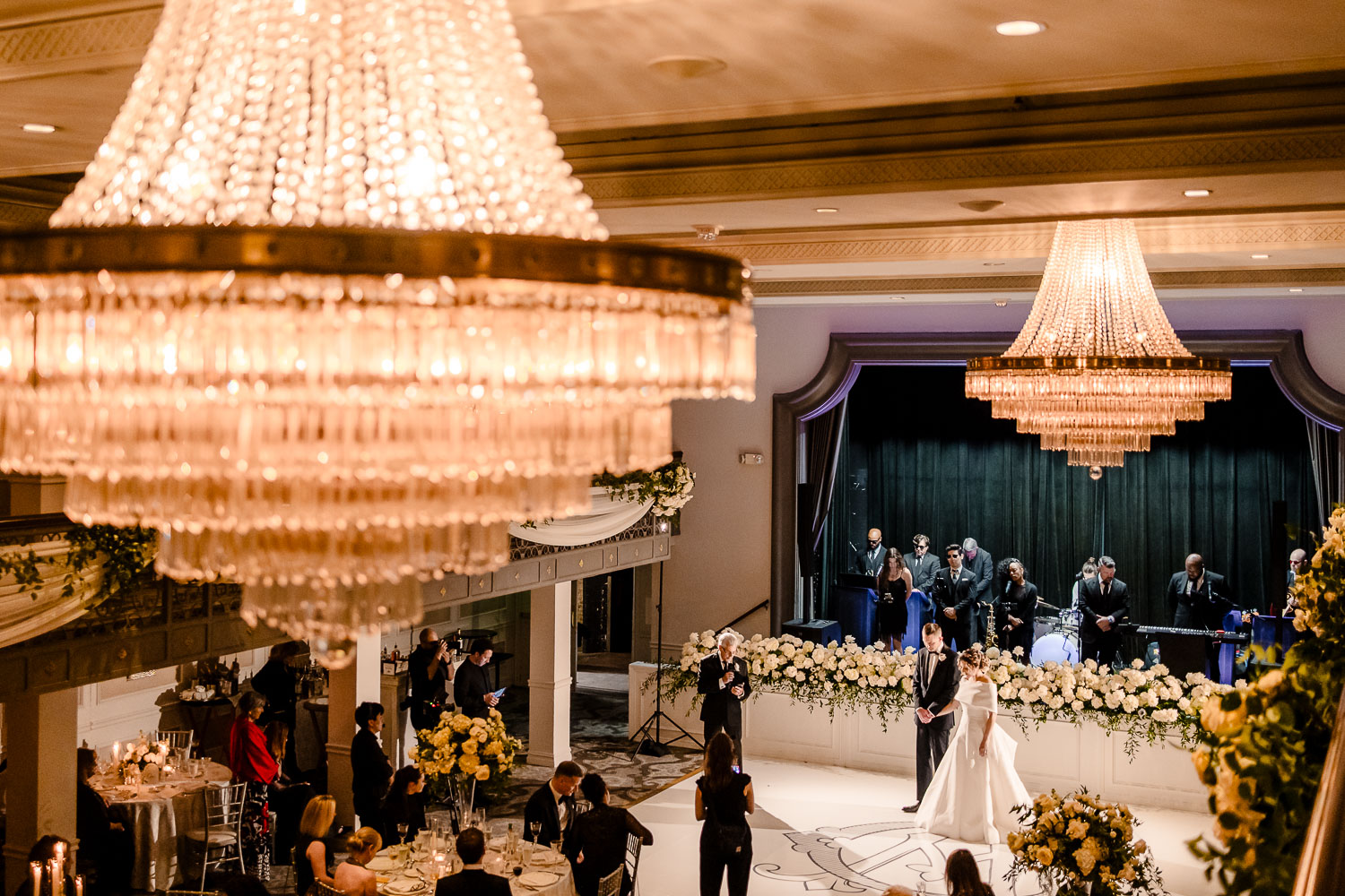 Elegant wedding reception with chandeliers.