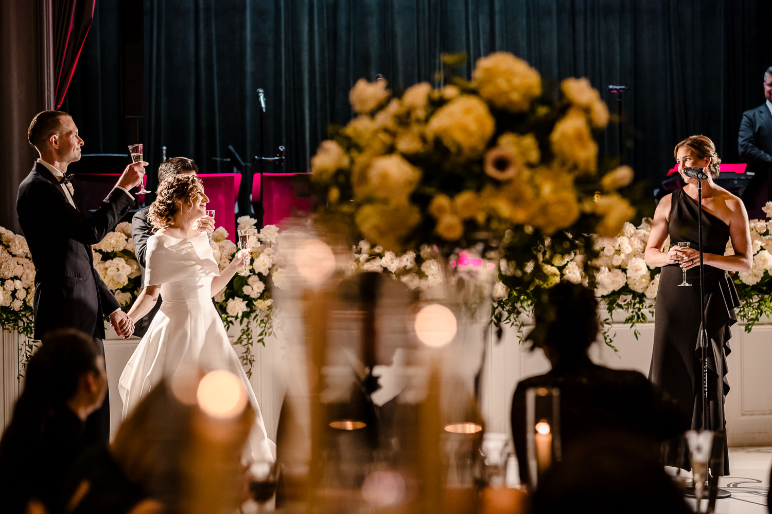 Couple toasting at elegant wedding reception.