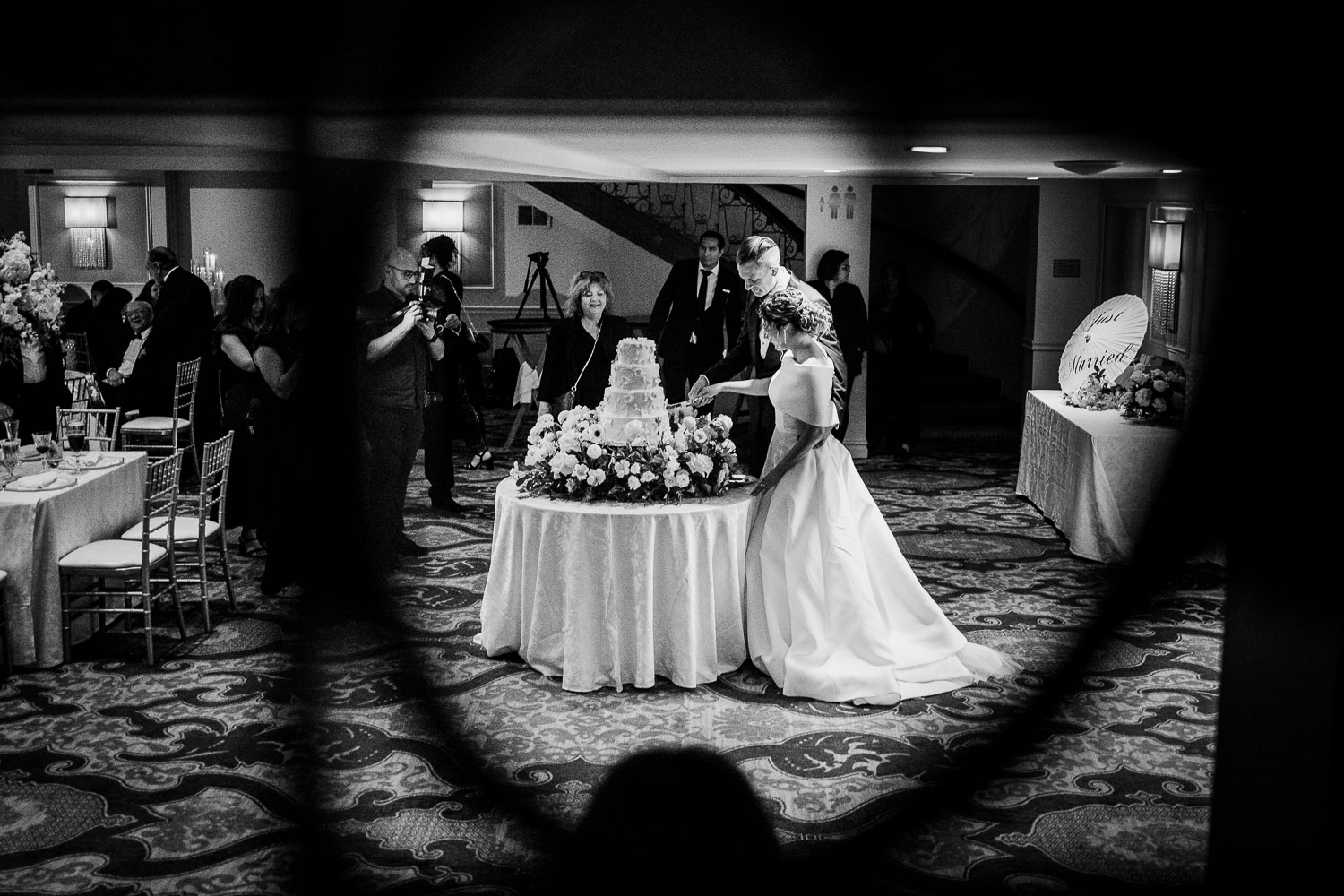 Bride with wedding cake and guests.