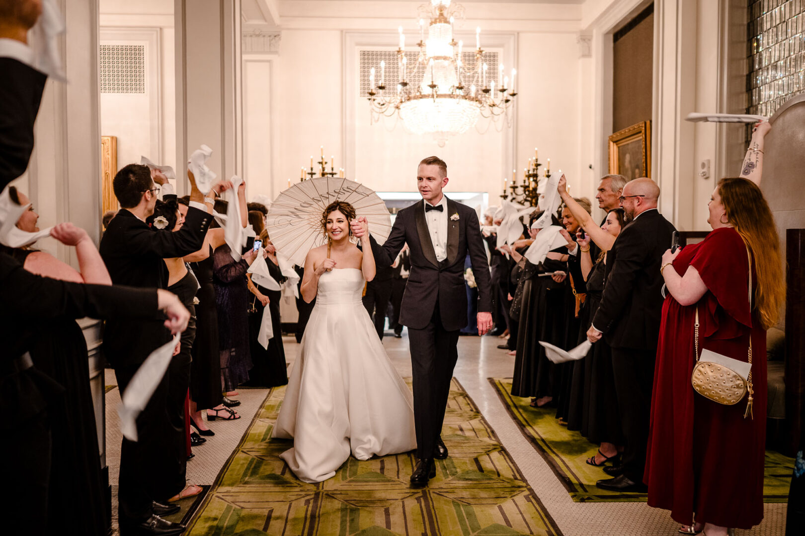 Couple celebrating with guests indoors.