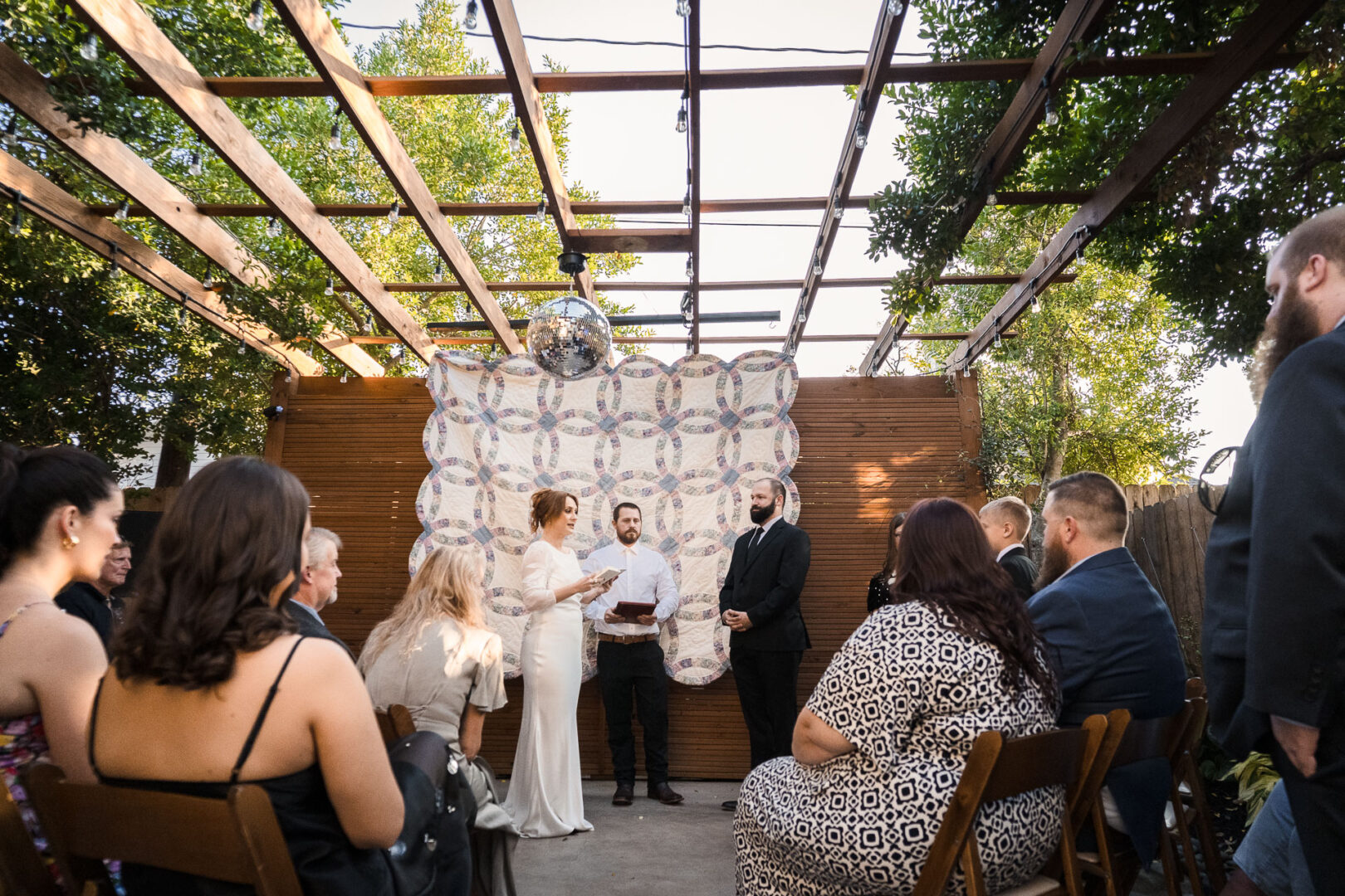 House + Backyard Wedding | Candace+Joey | Houston, TX 9 Outdoor wedding ceremony with guests seated.