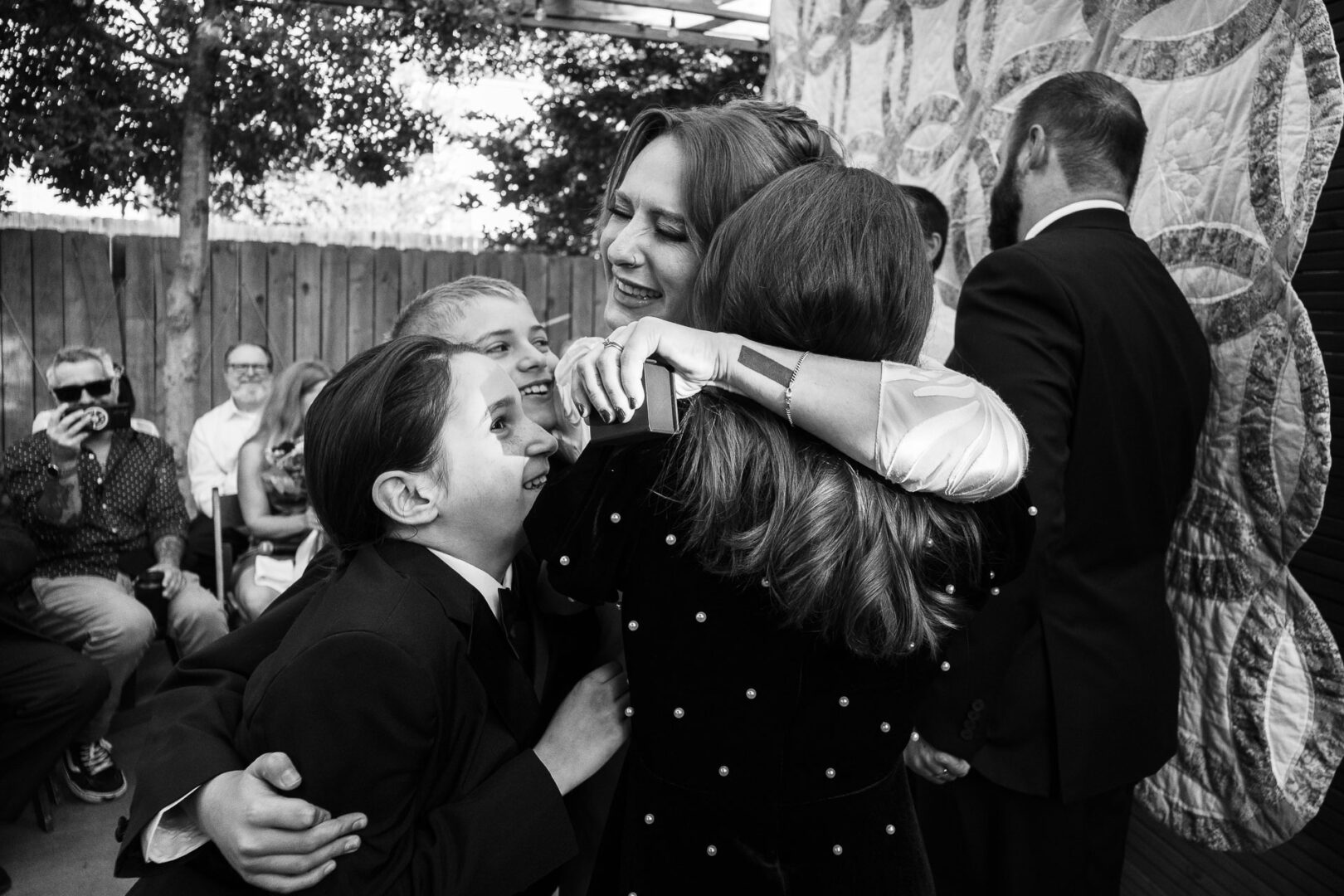 House + Backyard Wedding | Candace+Joey | Houston, TX 12 Group hug at a wedding ceremony.