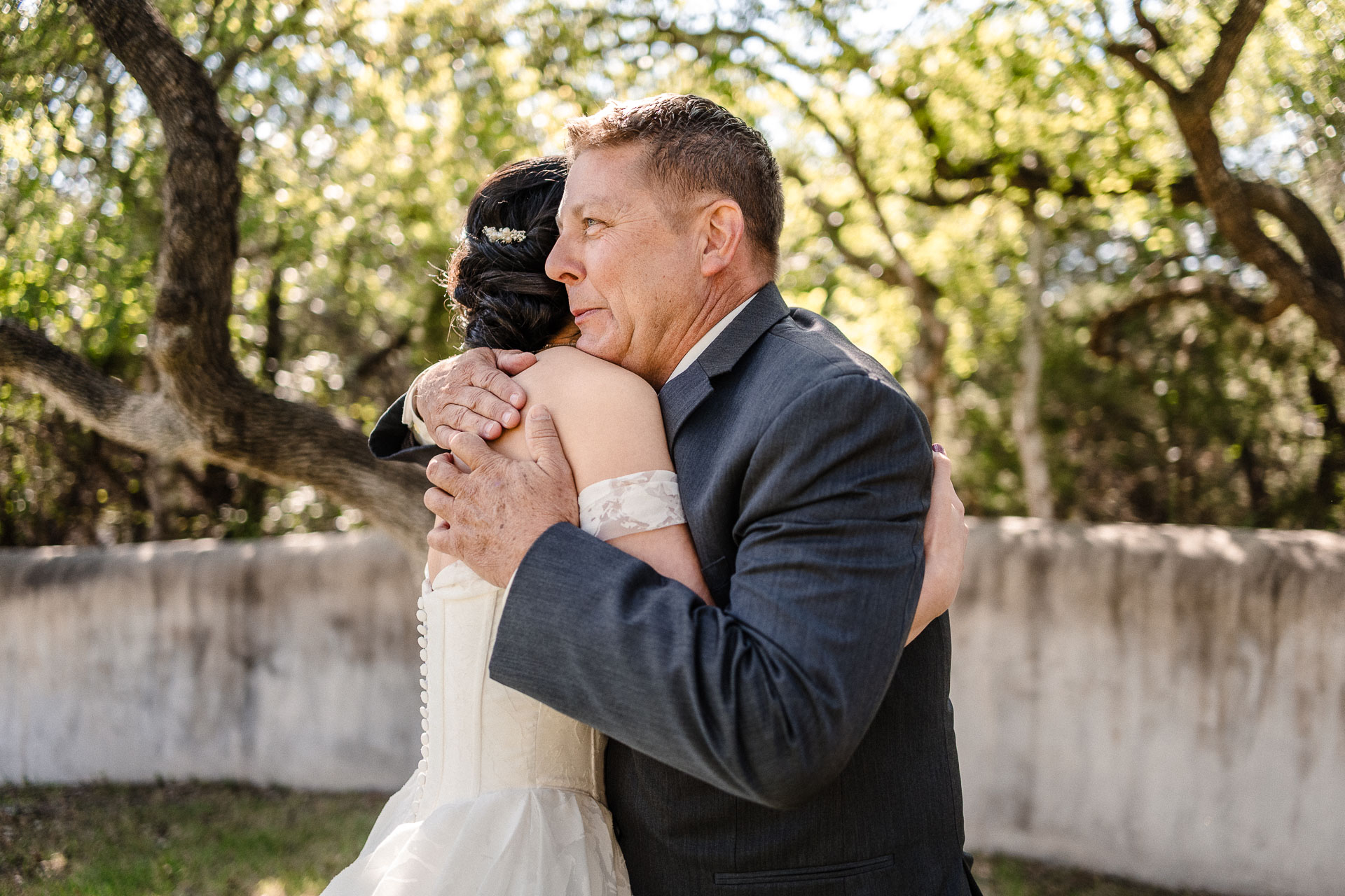 Emotional embrace during wedding celebration.