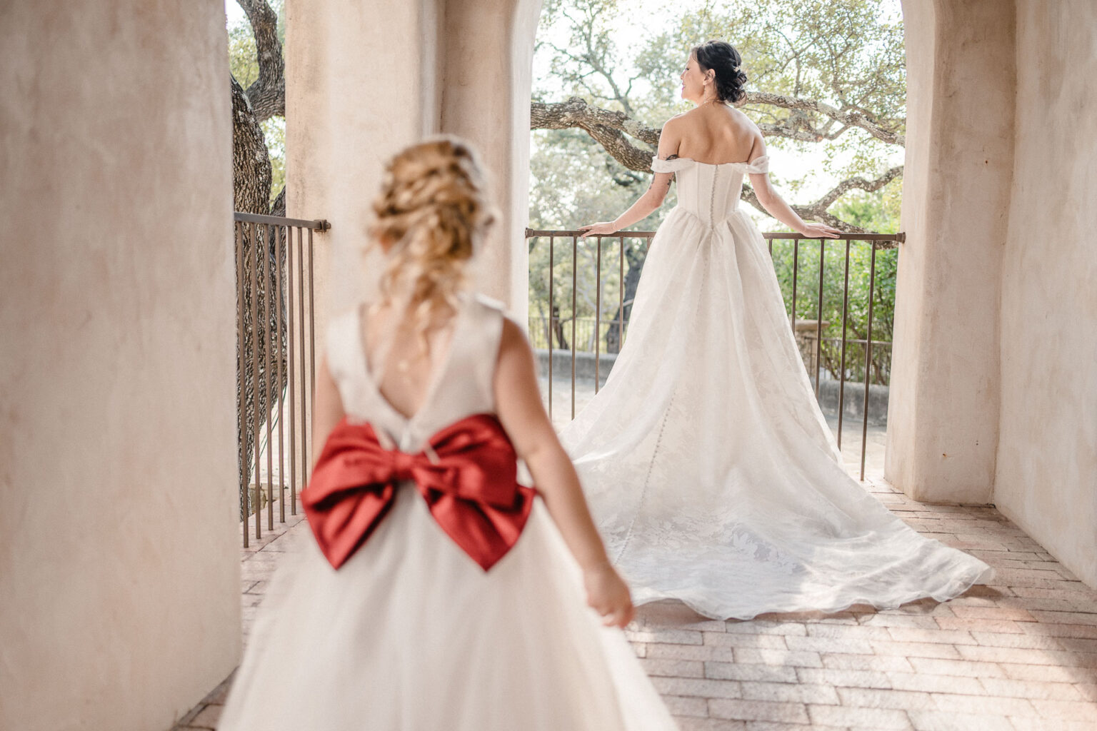 Bride and flower girl in wedding attire.