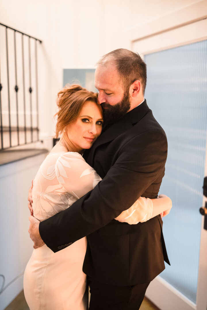 House + Backyard Wedding | Candace+Joey | Houston, TX 17 Couple embracing in wedding attire.