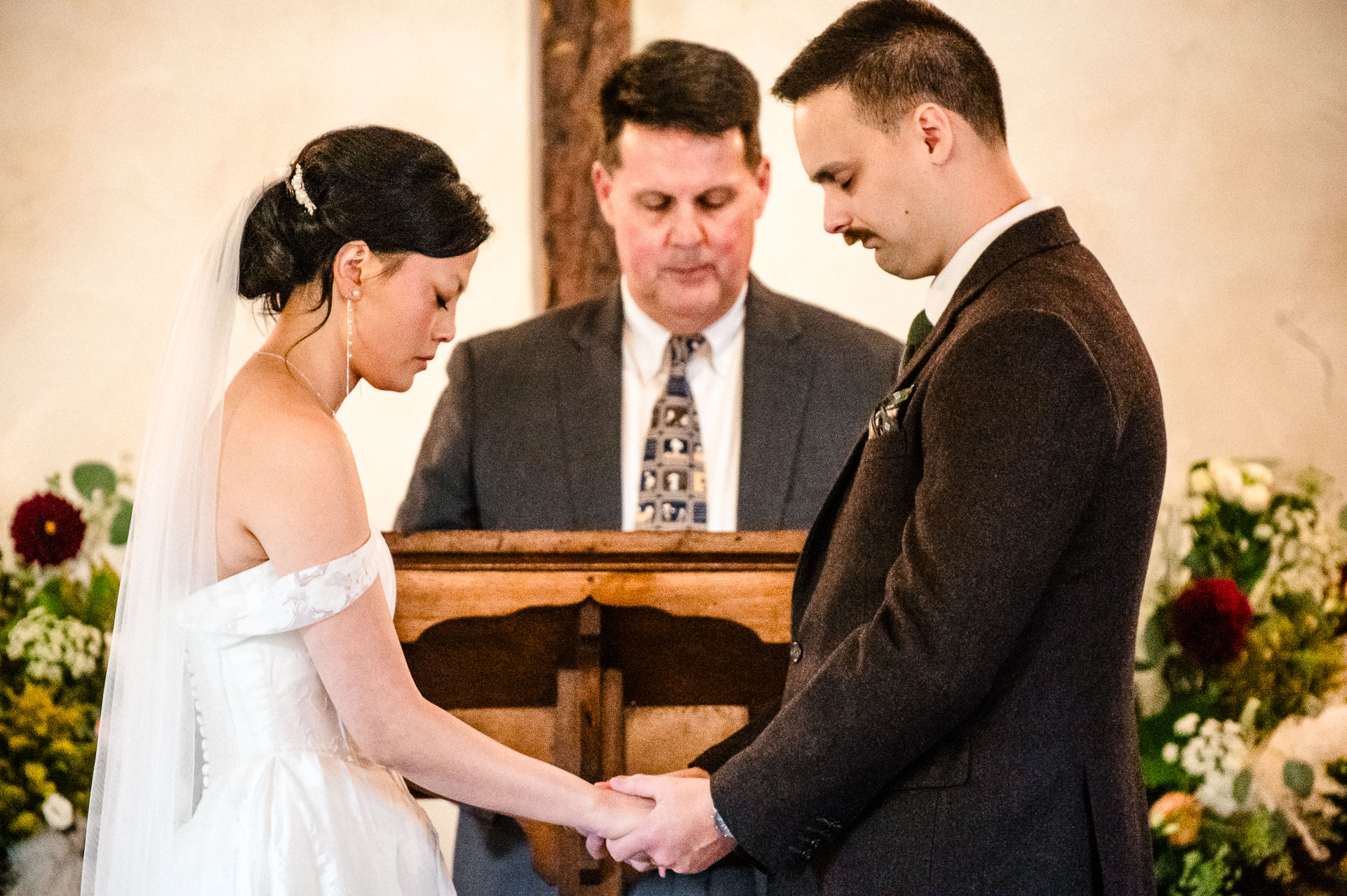 Couple exchanging vows at altar.