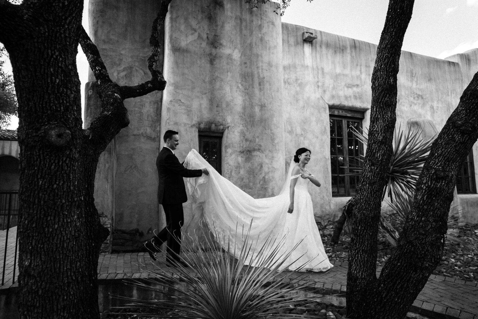 Bride and groom walking outdoors together.