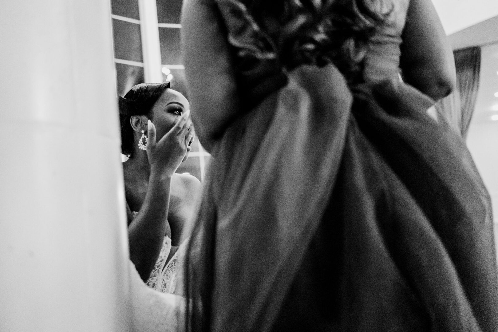 The Springs Weddings & Events | Candice + Larry 44 The bride gently wipes away tears, elegant in her gown, as she listens to a heartfelt toast over the phone during the reception.