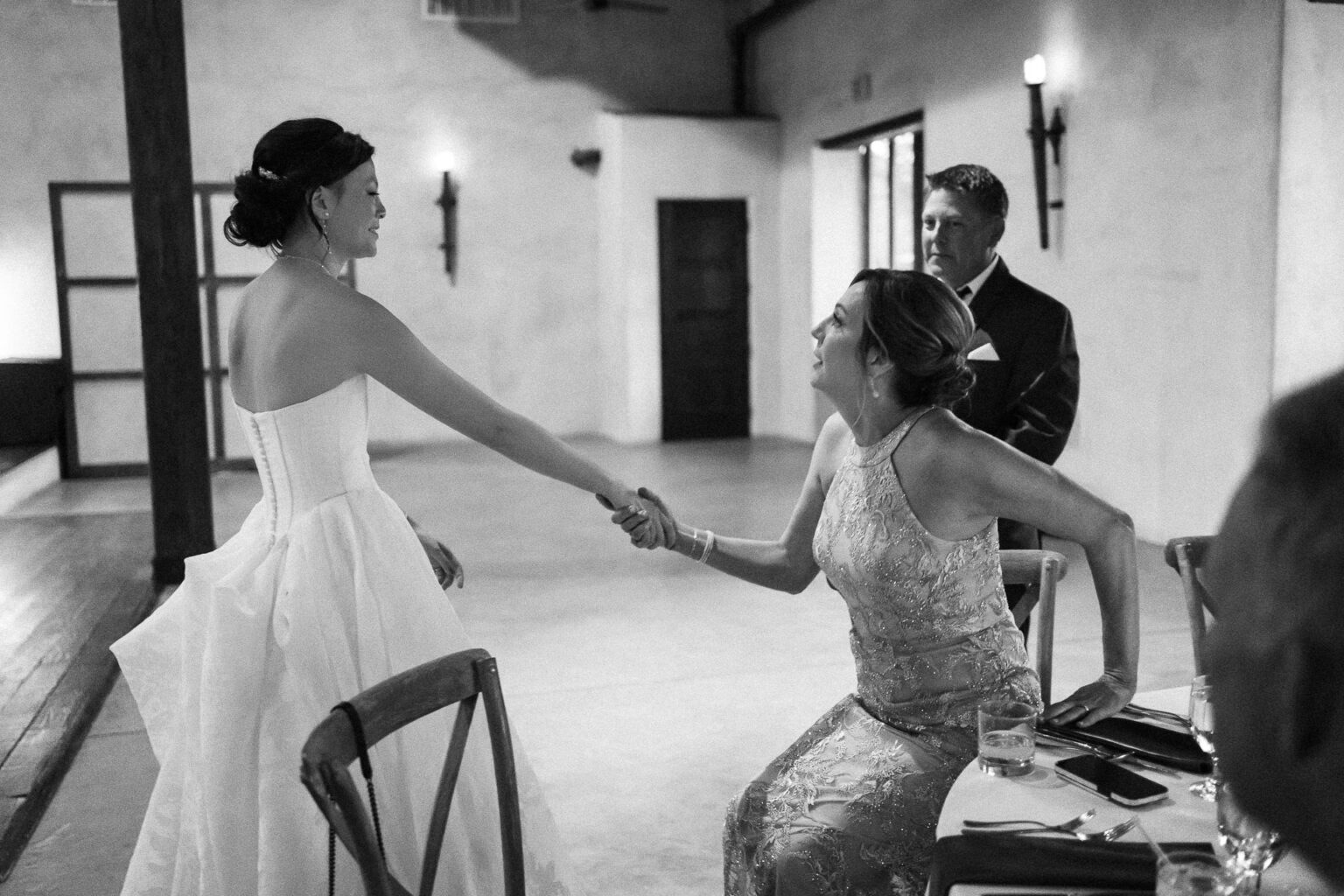 Bride greeting a guest warmly.