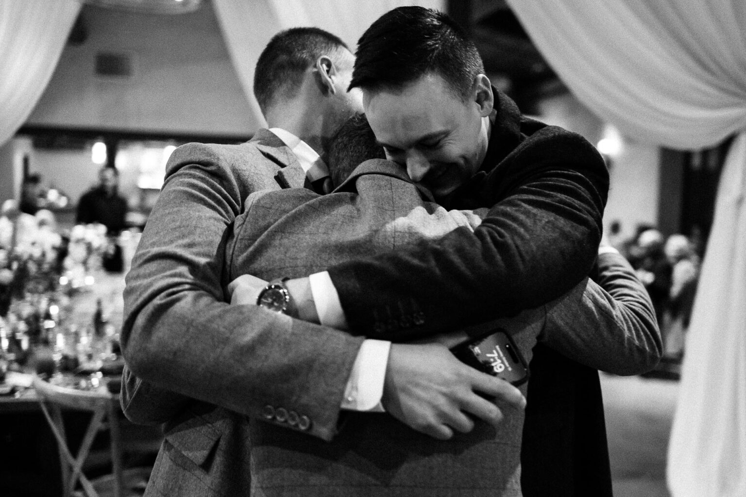 Emotional embrace among three friends.