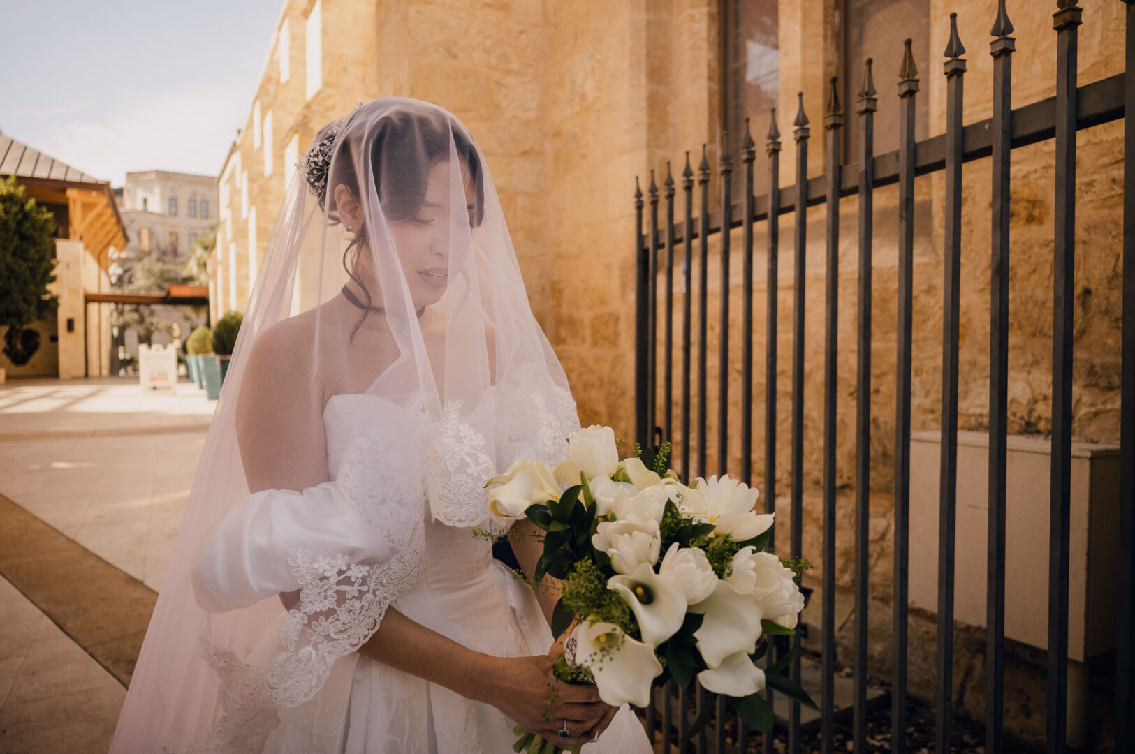 Noreena & Robert's Elegant Wedding at San Fernando Cathedral 16 Bride holding bouquet near cathedral.