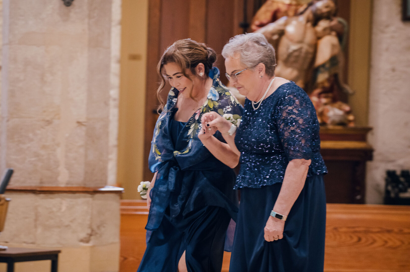 Noreena & Robert's Elegant Wedding at San Fernando Cathedral 26 Two women walking in formal attire.