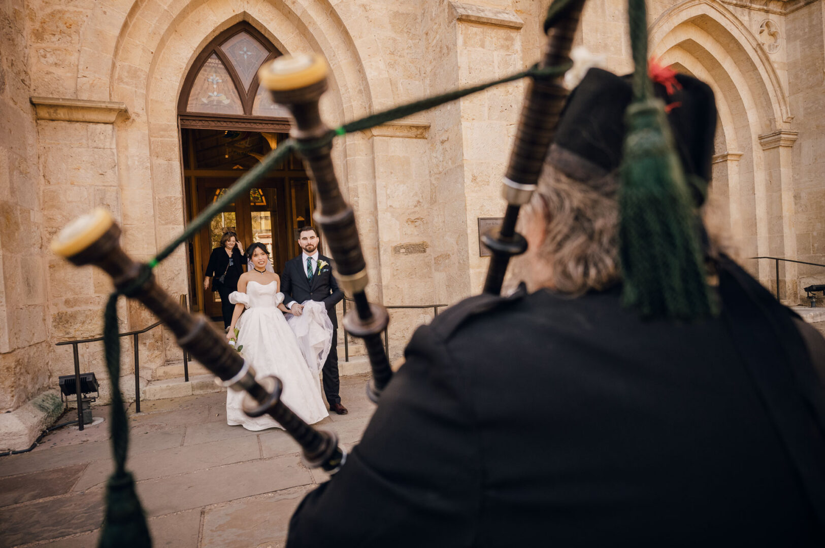 Noreena & Robert's Elegant Wedding at San Fernando Cathedral 34 Bagpiper at wedding ceremony entrance.