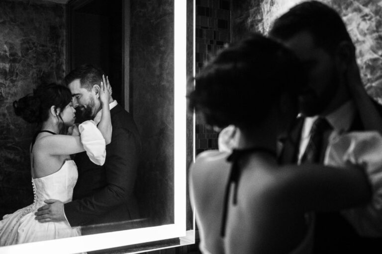 Couple embracing in a mirror reflection at St Anthony hotel