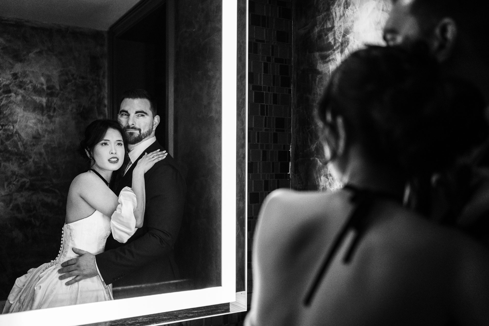 Couple embracing in wedding attire.