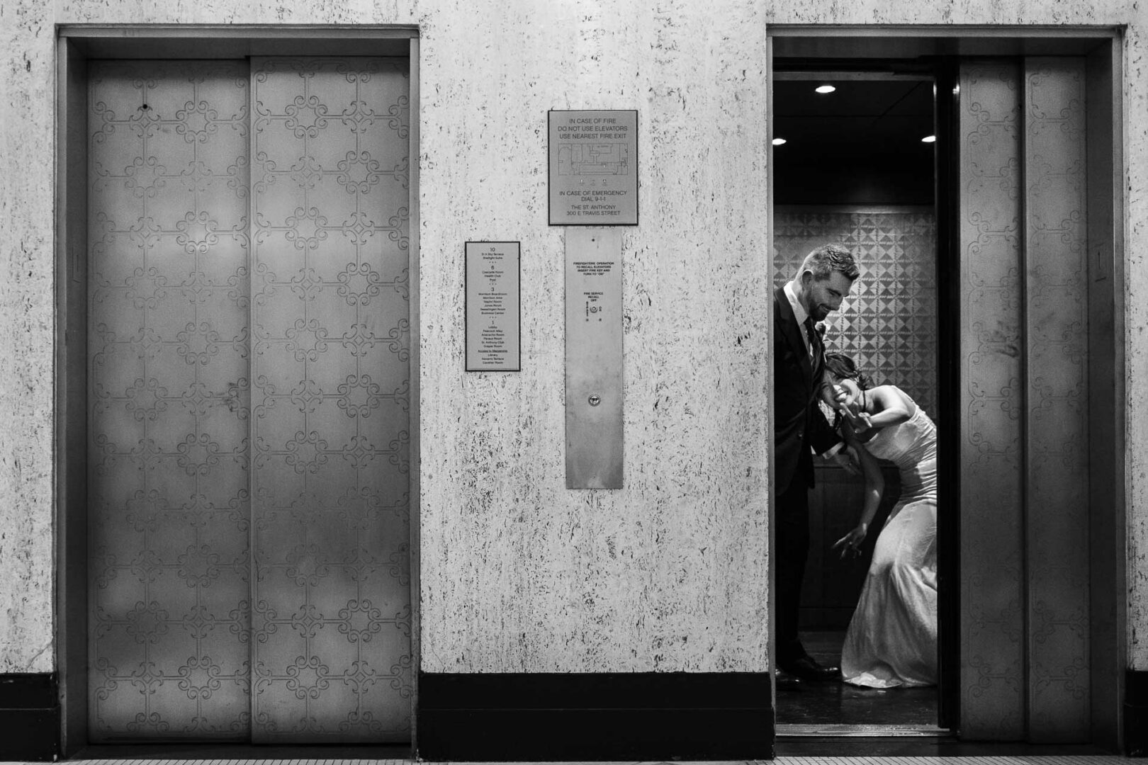 Couple in elevator, intimate moment.