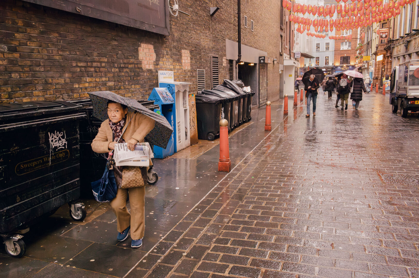 A local picks up a newspaper in Chinatown, London