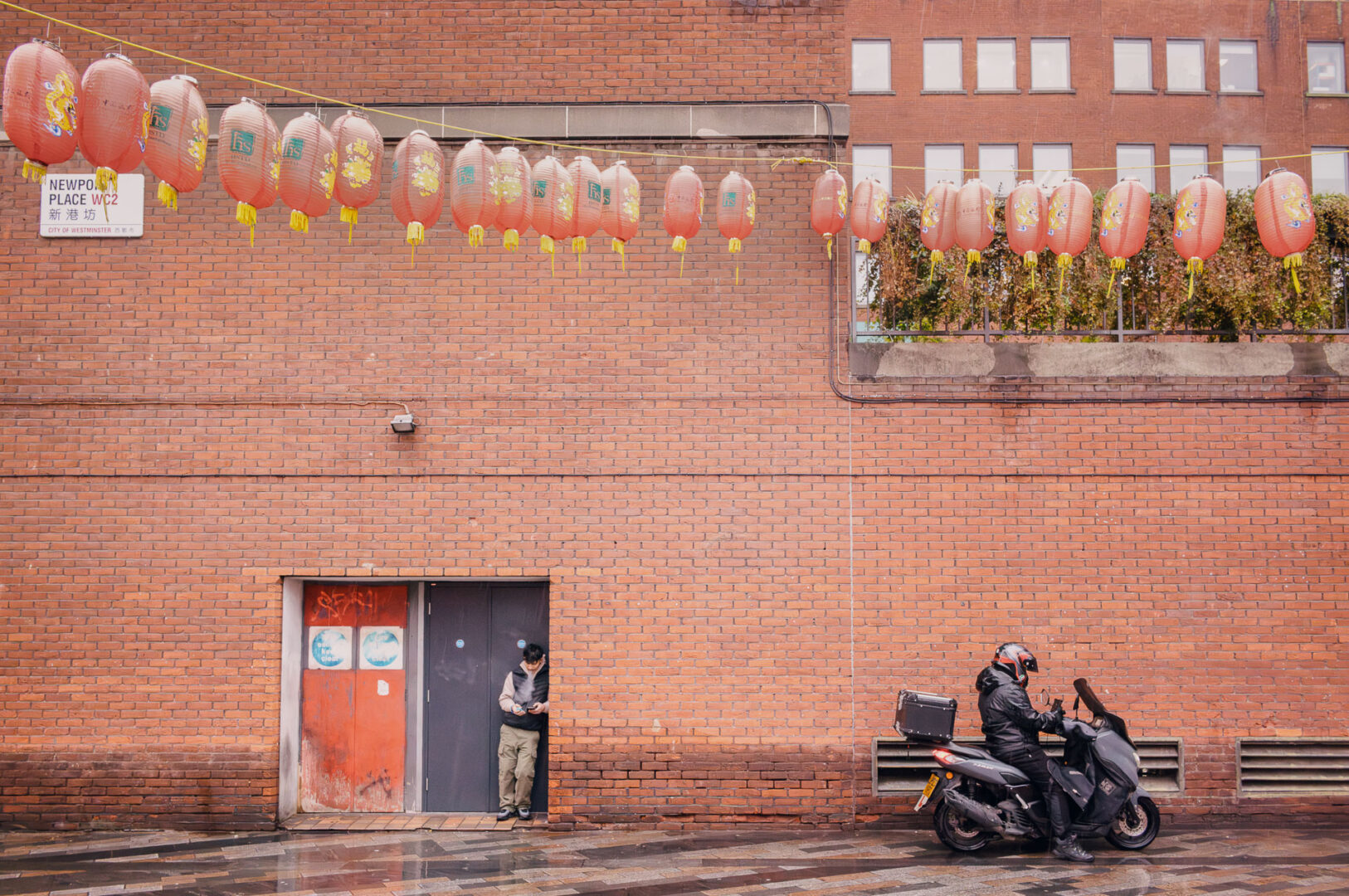 A worker and motorcyclist in Chinatown, London