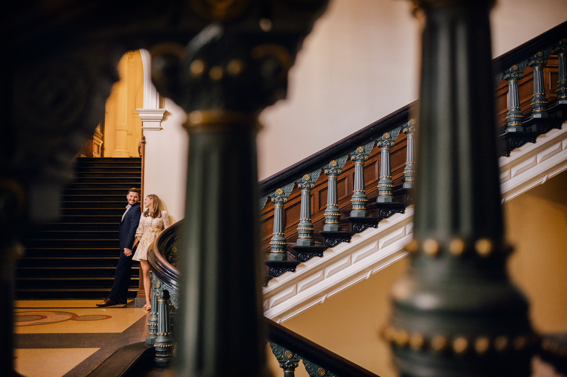 Engagement Session in the Texas State Capitol 5 Couple standing on staircase, romantic setting.