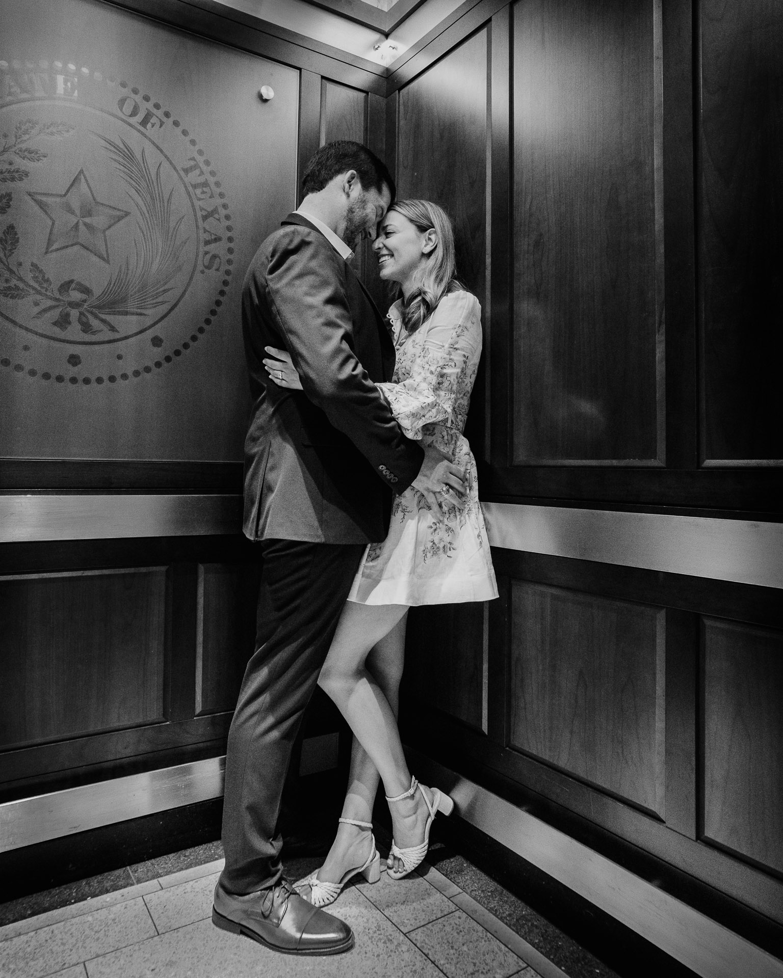 Engagement Session in the Texas State Capitol 7 Couple embracing in elevator, romantic moment.