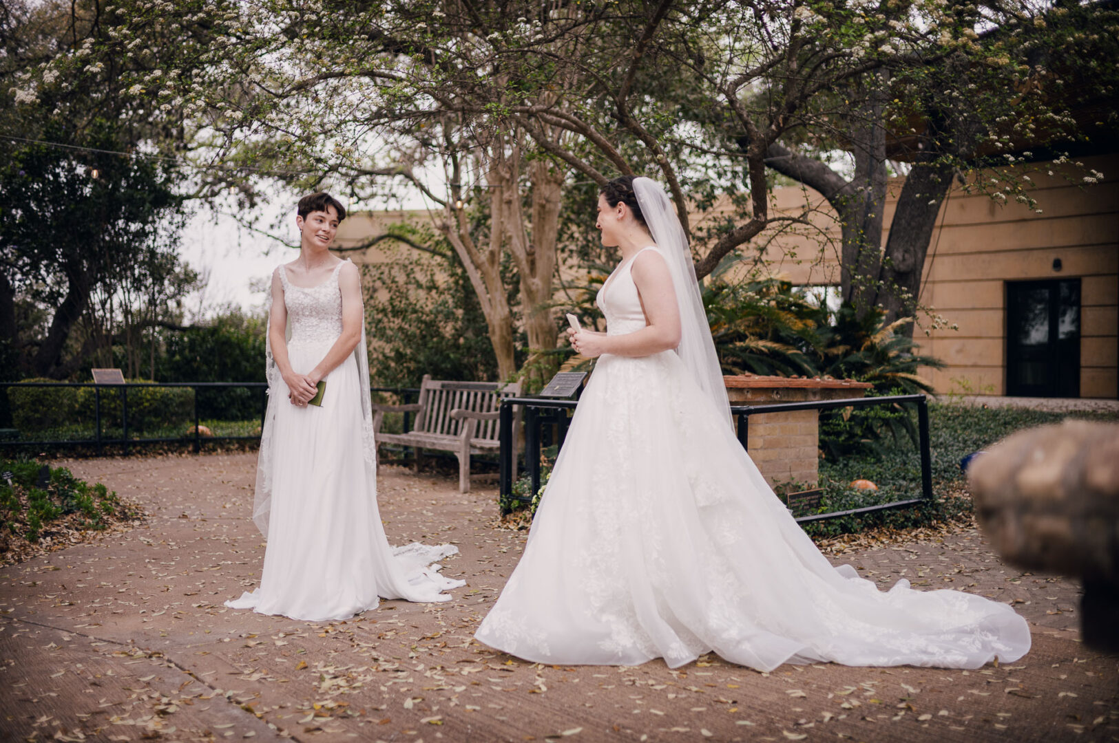 Winter Wedding at Botanical Gardens, San Antonio, Texas 8 Two brides in wedding dresses outdoors.