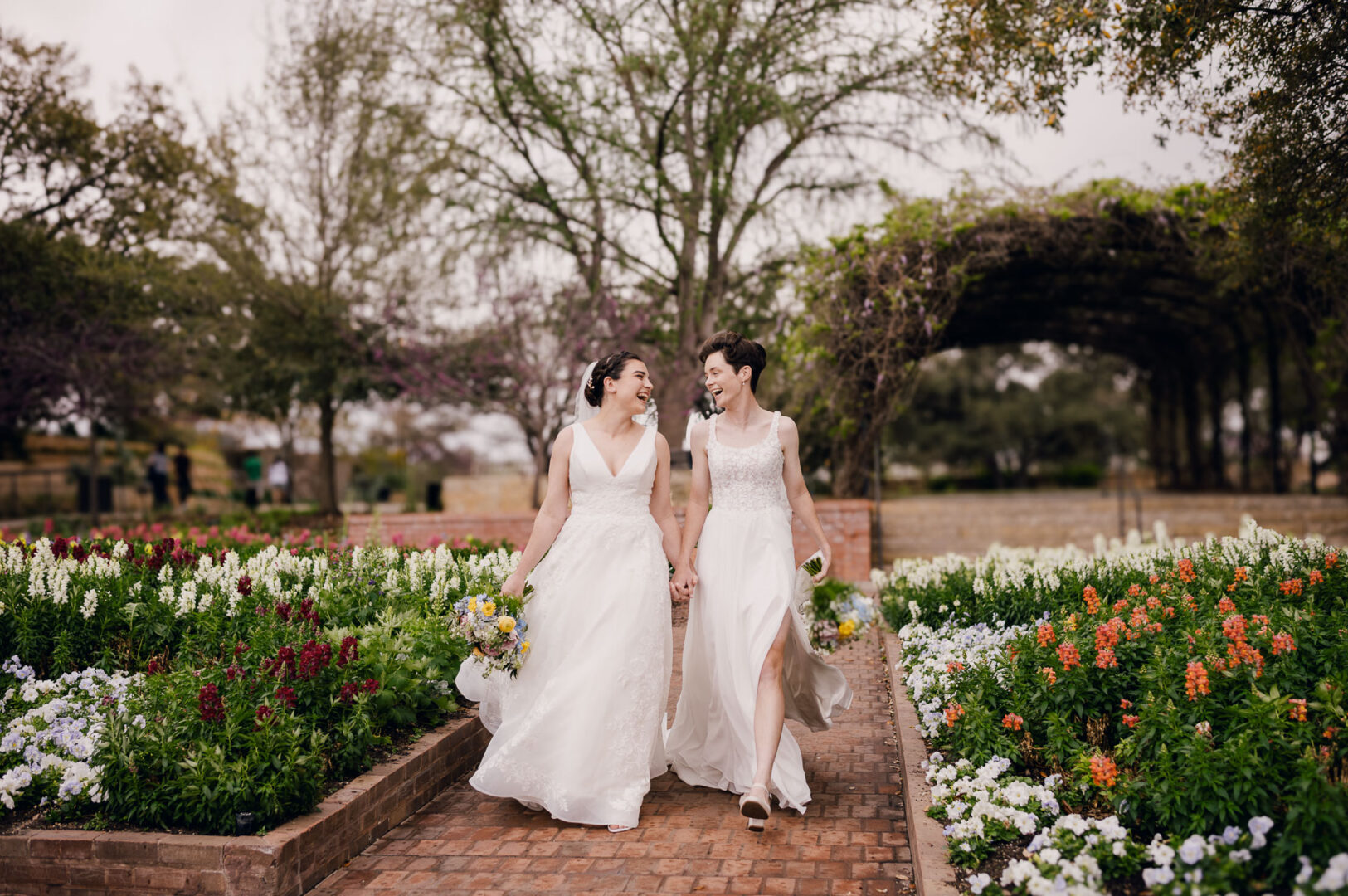 Winter Wedding at Botanical Gardens, San Antonio, Texas 35 Brides walking through floral garden path.