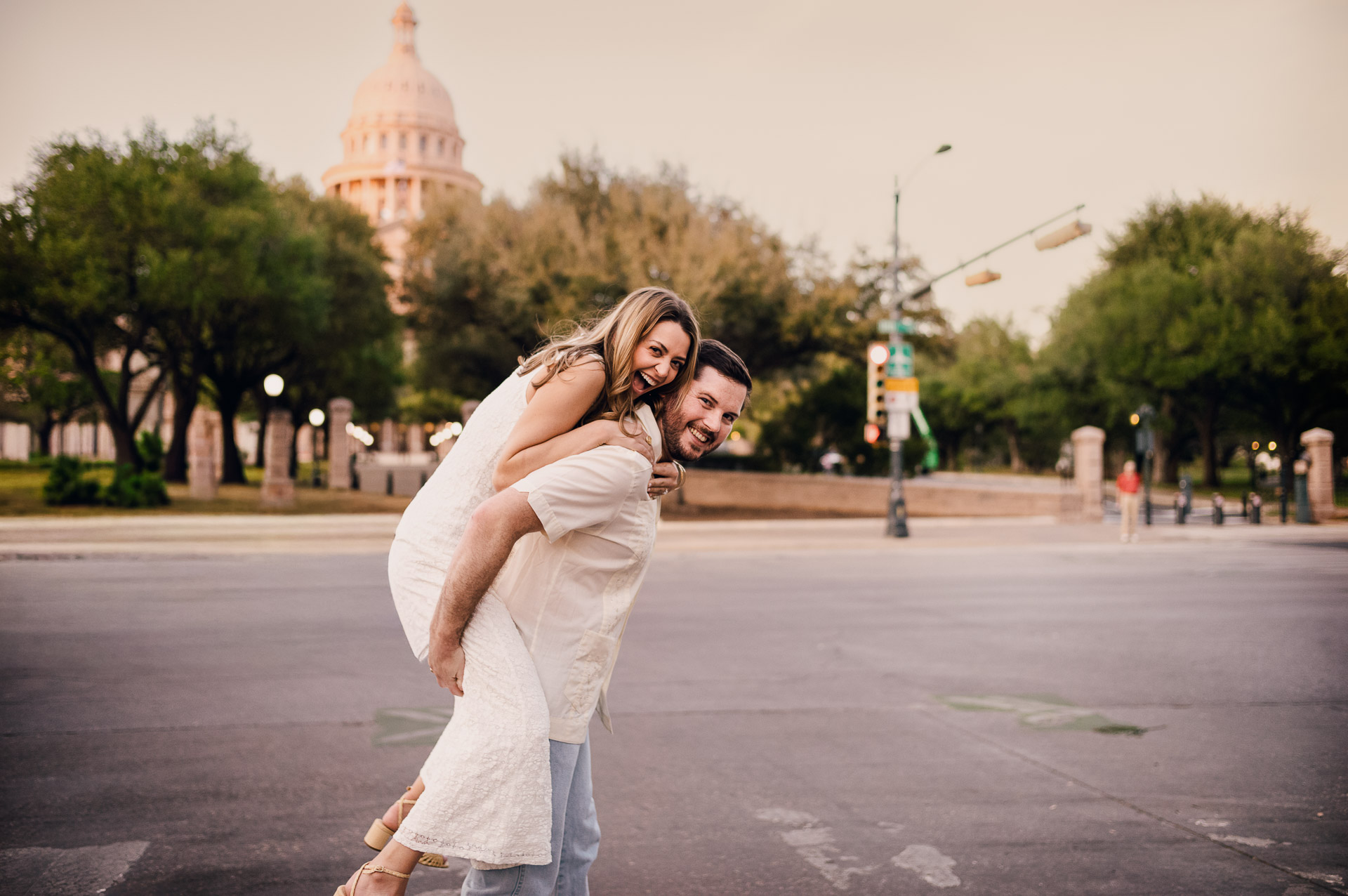 Engagement Session in the Texas State Capitol 14 Couple enjoying playful moment outdoors.