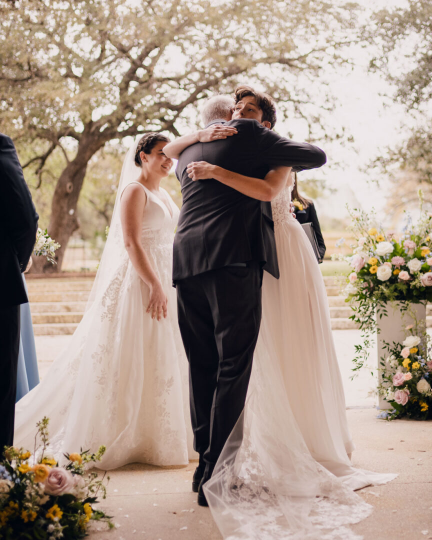 Winter Wedding at Botanical Gardens, San Antonio, Texas 21 Emotional wedding embrace with flowers.