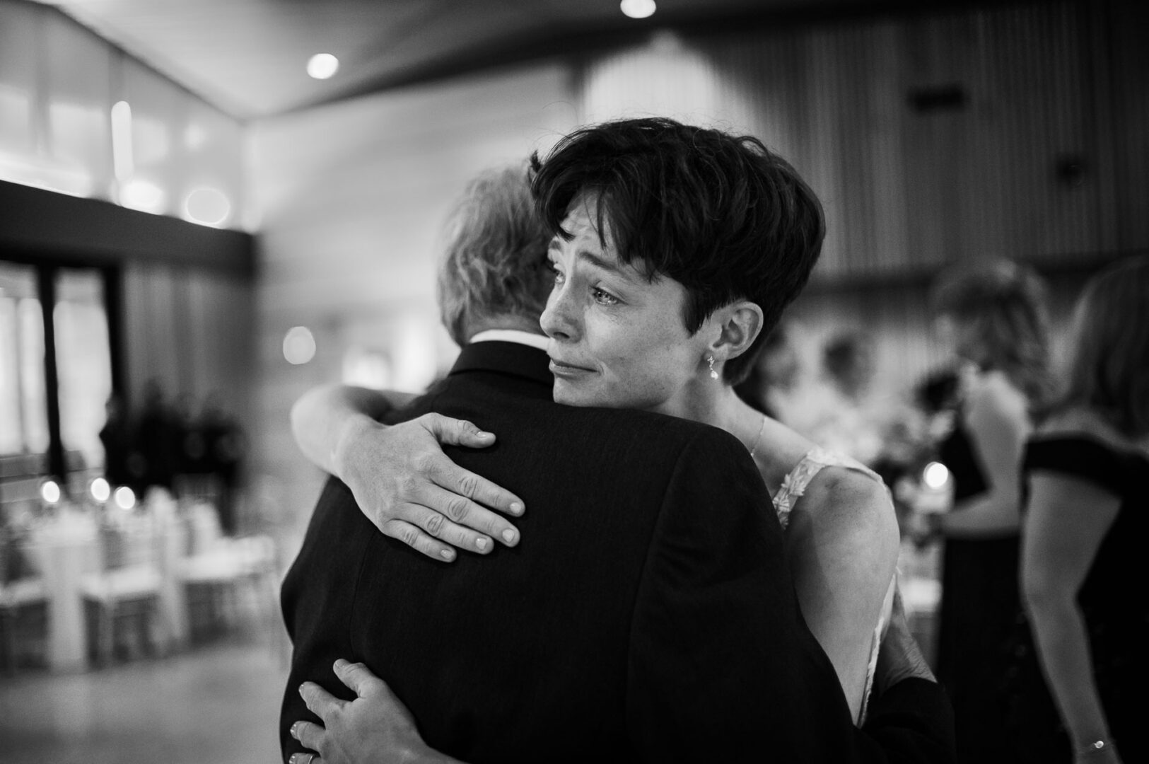 Couple embracing at wedding reception.