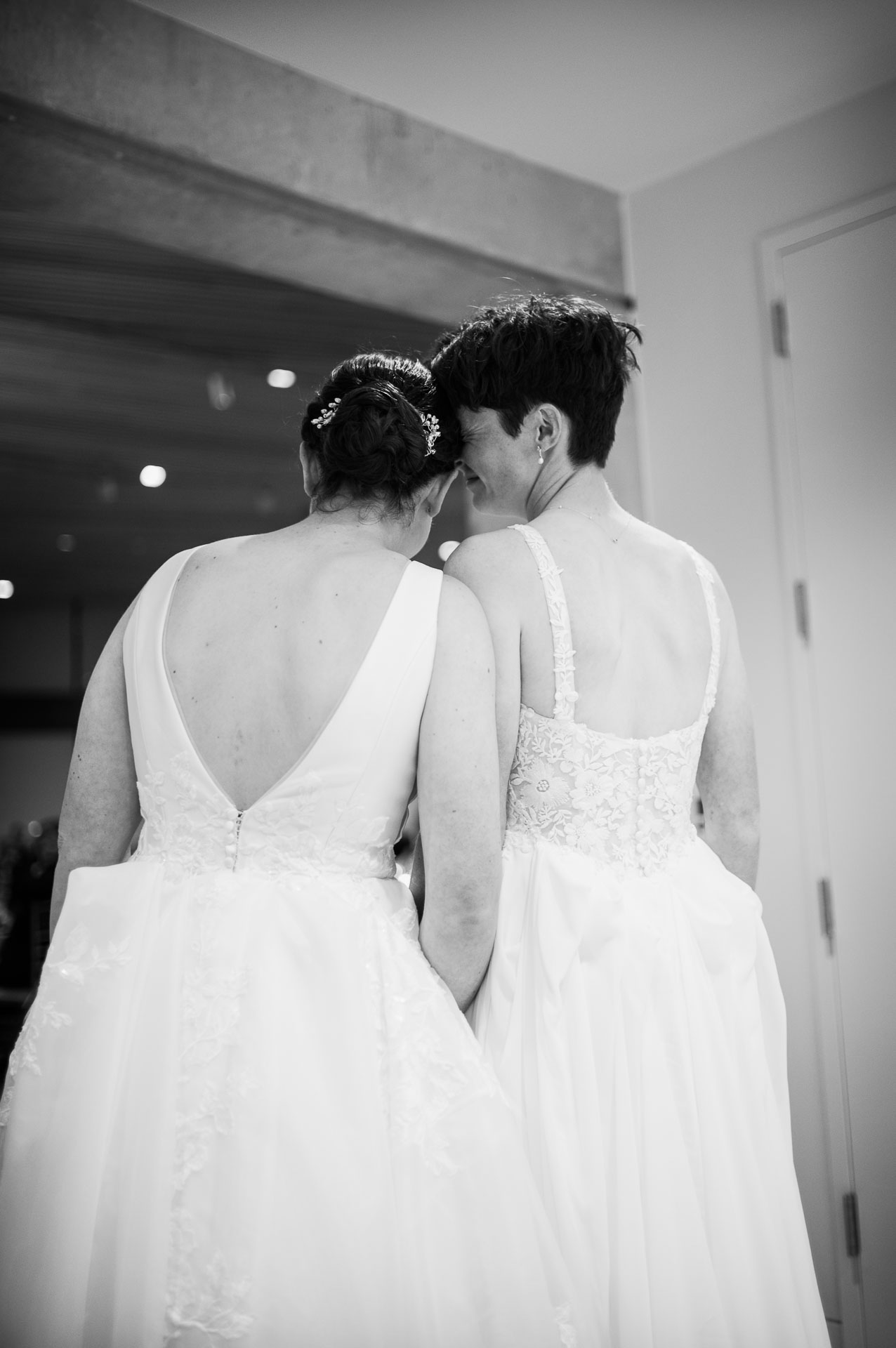 Two brides in elegant wedding dresses.