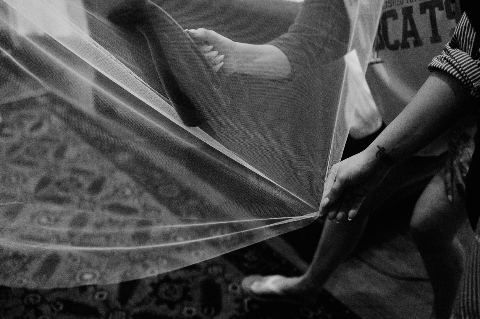 Vibrant Spring Wedding at Shiraz Gardens in Bastrop 2 Black and white documentary wedding detail of the bride’s dress and fabric at Shiraz Gardens in Bastrop, Texas.