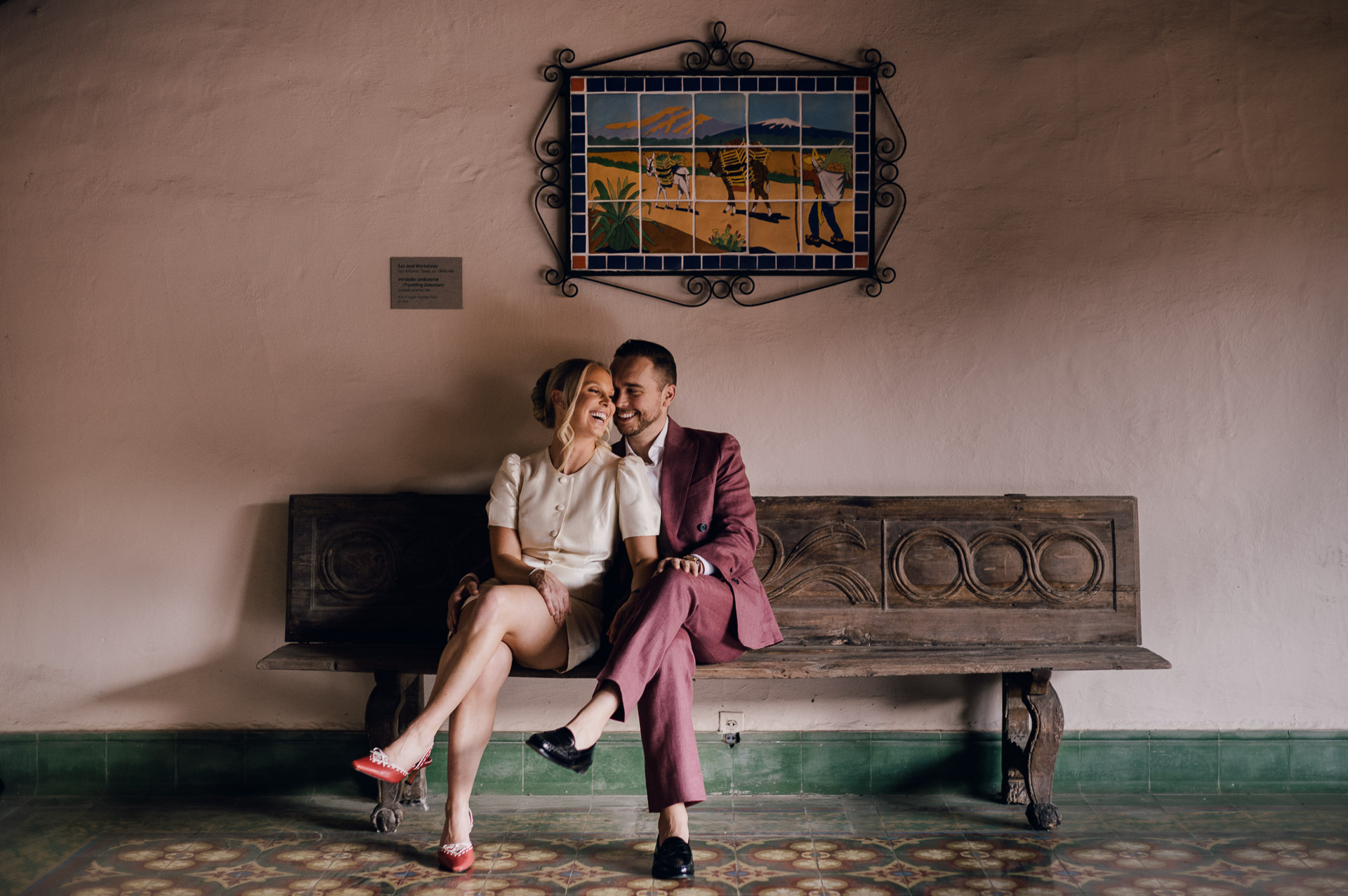 Couple sitting together, smiling warmly.