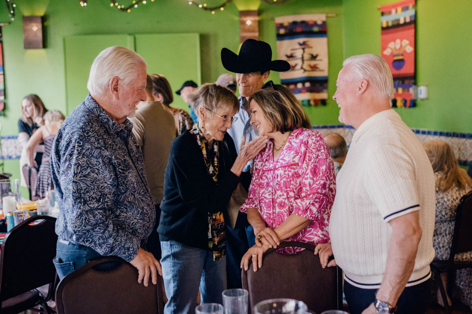 Guests greeting one another during rehearsal dinner at Casa Rio on the River Walk