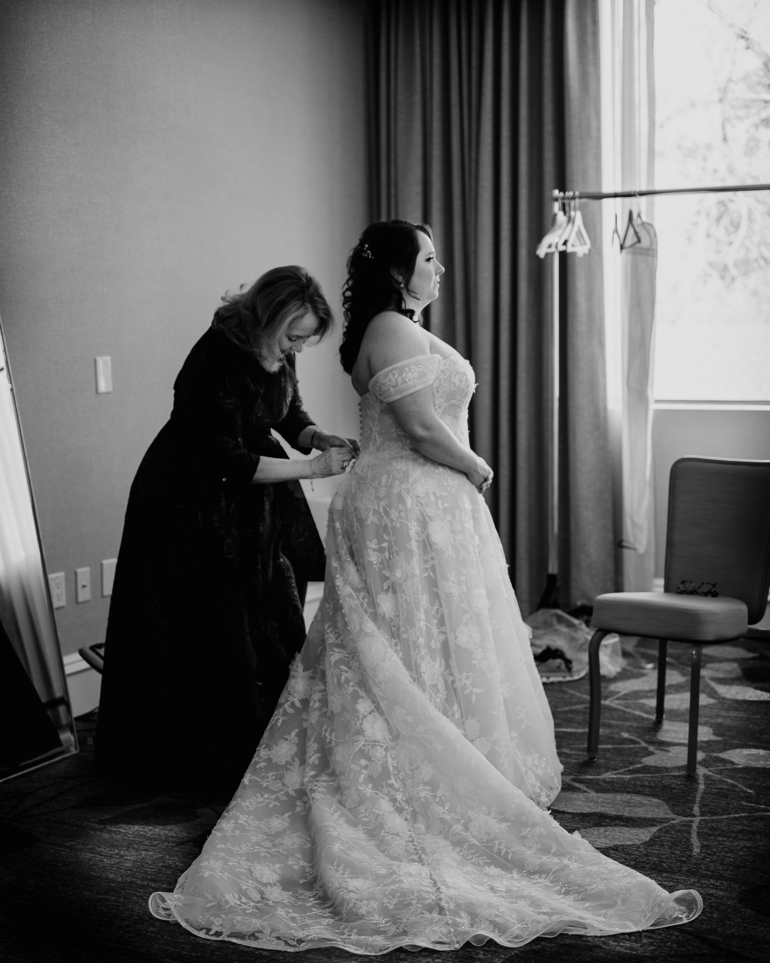 Oak Tree Ceremony & Candlelit Reception at The Houstonian 4 Bride having her dress adjusted during getting ready at The Houstonian Hotel.