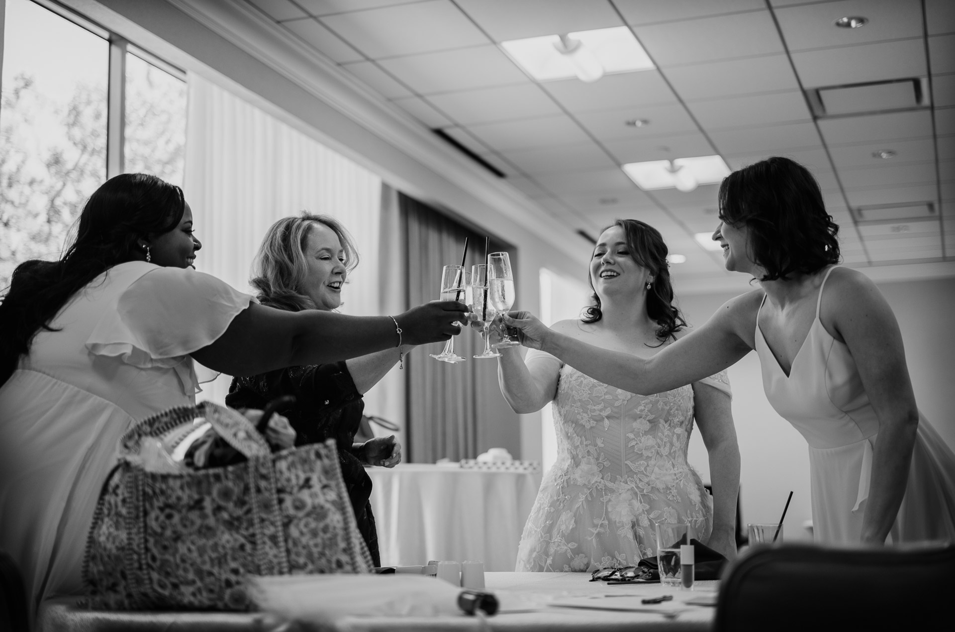 Oak Tree Ceremony & Candlelit Reception at The Houstonian 7 Bride and bridesmaids raising glasses during a getting-ready toast at The Houstonian Hotel.