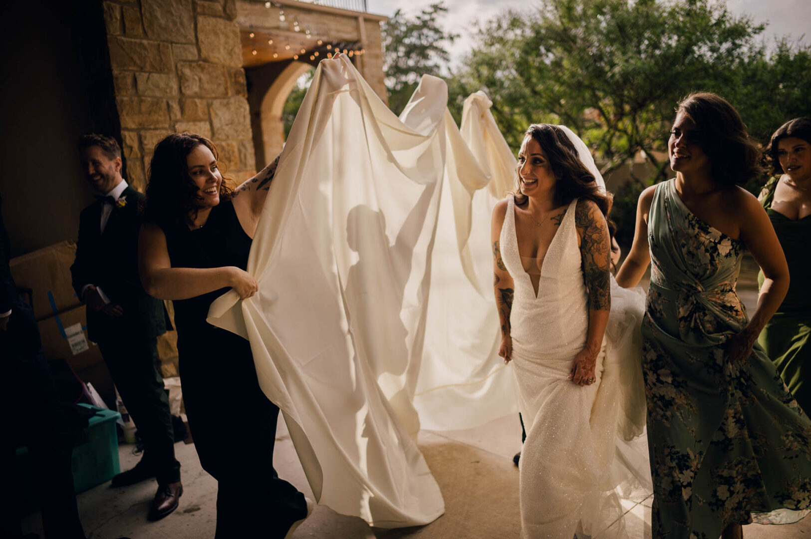 Vibrant Spring Wedding at Shiraz Gardens in Bastrop 18 Documentary wedding image of the bride walking to the ceremony with her dress at Shiraz Gardens.