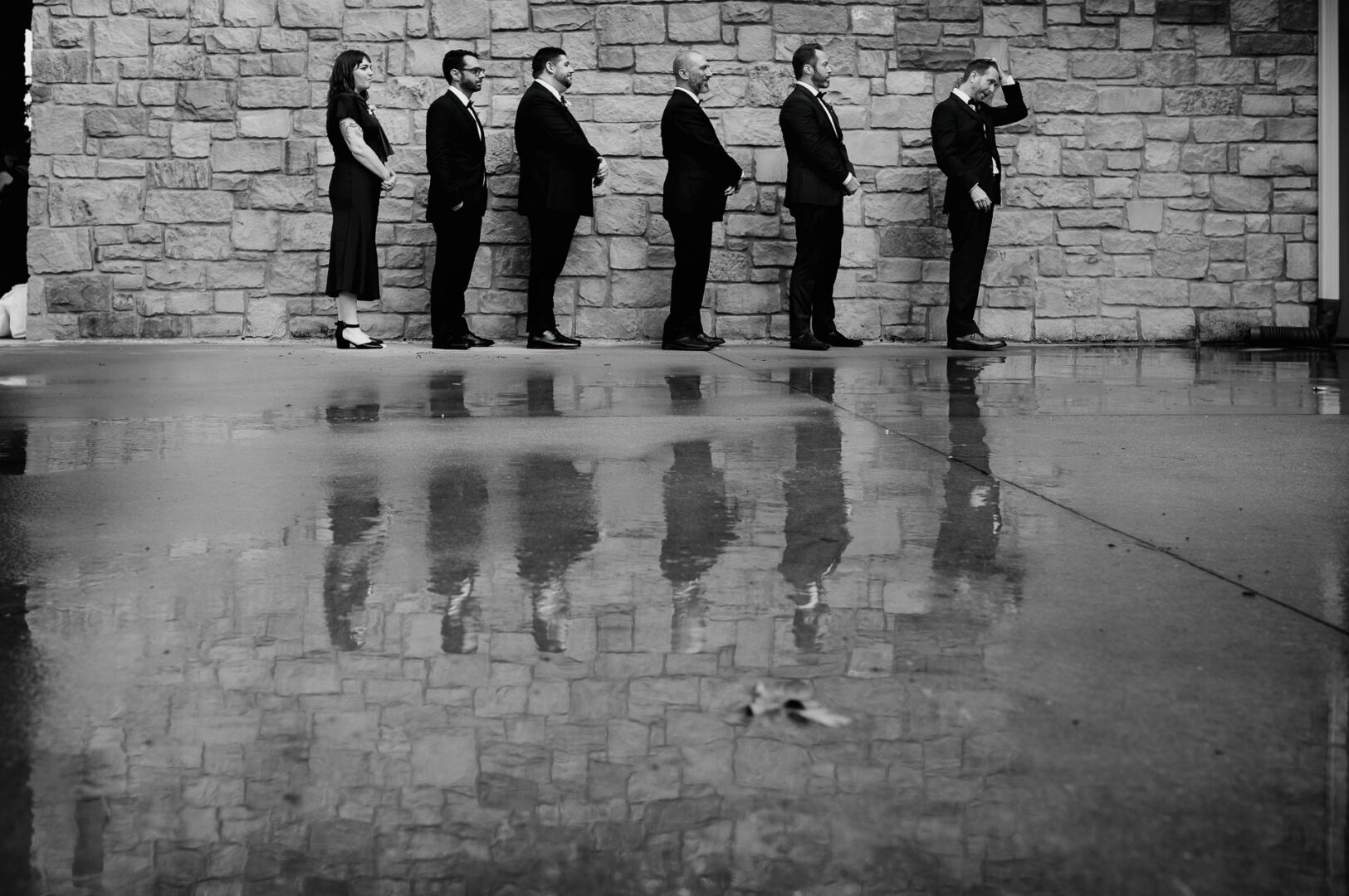 Vibrant Spring Wedding at Shiraz Gardens in Bastrop 21 Black and white wedding photo of the wedding party reflected in wet ground after rain at Shiraz Gardens.