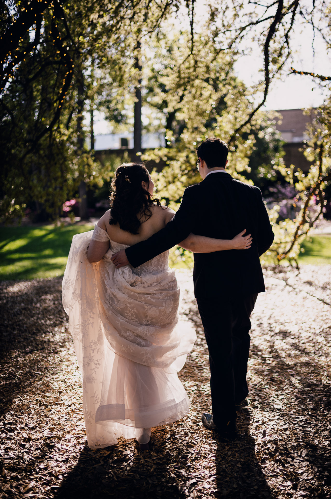 Oak Tree Ceremony & Candlelit Reception at The Houstonian 37 Bride and groom embracing outdoors beneath the trees at The Houstonian Hotel.