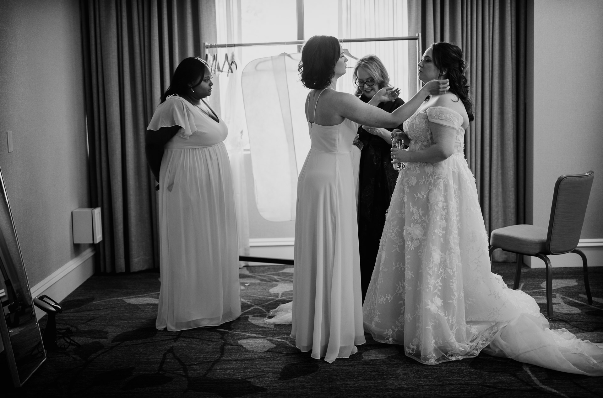 Oak Tree Ceremony & Candlelit Reception at The Houstonian 16 Bride getting ready with bridesmaids by the window at The Houstonian Hotel.