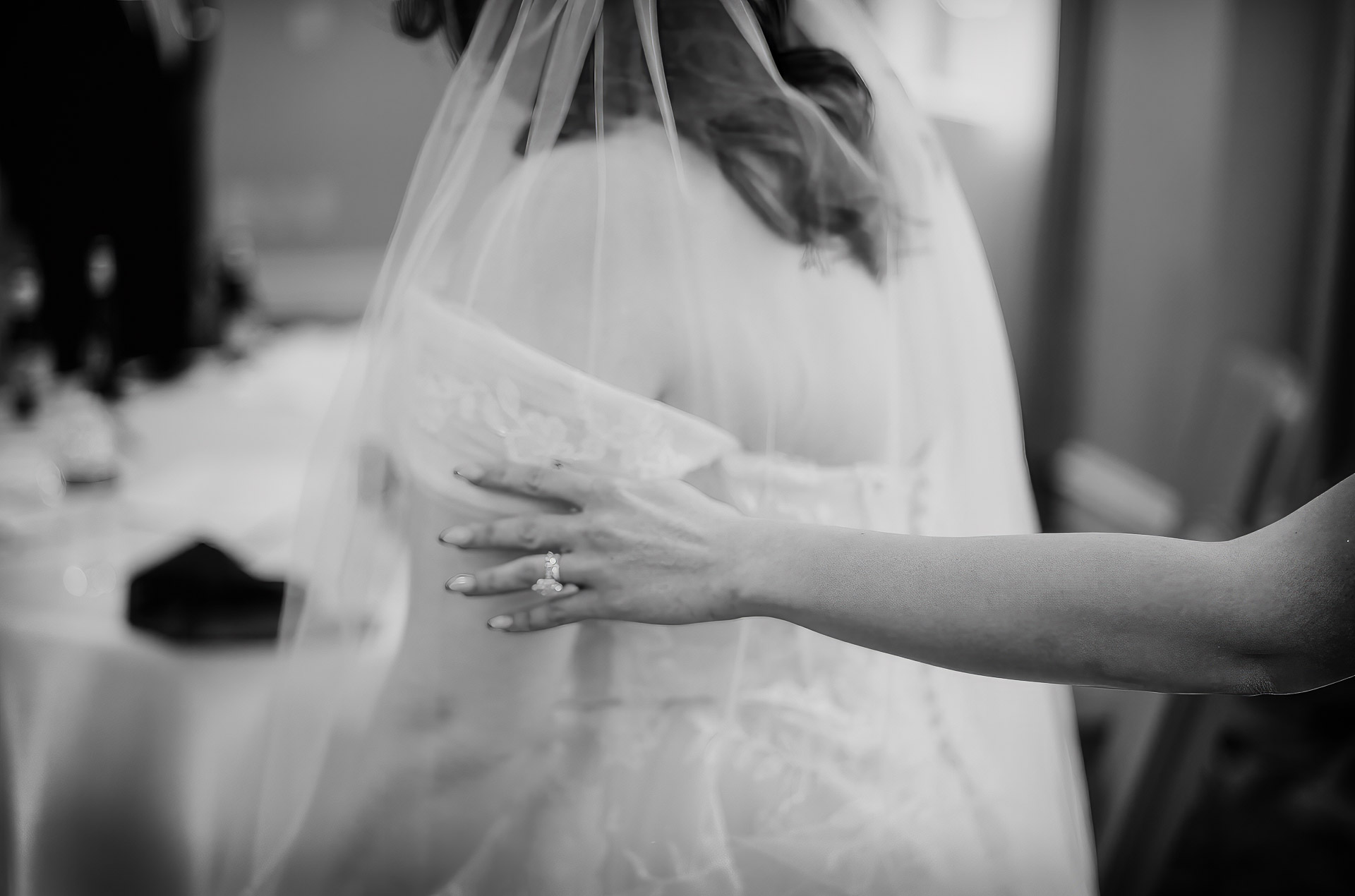 Oak Tree Ceremony & Candlelit Reception at The Houstonian 17 Black-and-white close-up of the bridemaid’s hands resting on her wedding dress.