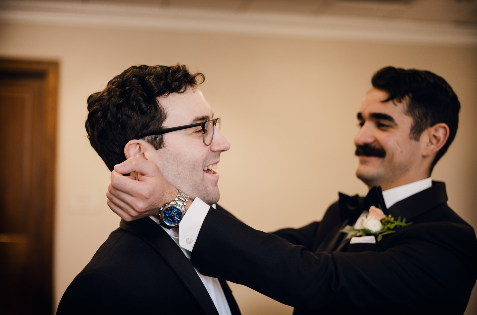 Oak Tree Ceremony & Candlelit Reception at The Houstonian 19 Groom getting ready with help adjusting his boutonniere or lapel.